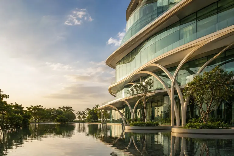 Architectural concept of green glass buildings and curved ivory structures
