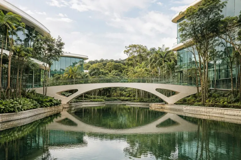 Concept of a bridge connecting buildings across reflective water